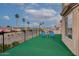 Spacious balcony with artificial turf and blue chairs overlooking a residential neighborhood with palm trees at 5940 W Robinson Way, Chandler, AZ 85226