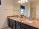 Bathroom featuring granite countertop, undermount sinks, and a large vanity mirror at 5940 W Robinson Way, Chandler, AZ 85226