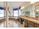Bright bathroom featuring a deep soaking tub with mosaic tile and marble countertops at 5940 W Robinson Way, Chandler, AZ 85226