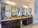 Bathroom featuring dual vanity sinks, granite countertops, and large mirrors providing ample space at 5940 W Robinson Way, Chandler, AZ 85226