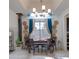 Formal dining room with large window, elegant chandelier, and stylish decor at 5940 W Robinson Way, Chandler, AZ 85226