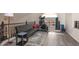 Bright loft featuring hardwood floors, a black futon, and exercise equipment near the railing and window at 5940 W Robinson Way, Chandler, AZ 85226