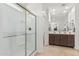 An en-suite bathroom offers a step-in shower, a dual sink vanity, and tile flooring at 607 W Tenia Trl, San Tan Valley, AZ 85140