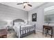 Cozy bedroom featuring a ceiling fan, patterned wallpaper, and a comfortable wrought iron bed frame at 607 W Tenia Trl, San Tan Valley, AZ 85140