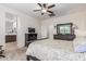 A primary bedroom offers an ensuite bath, ceiling fan, and a neutral color scheme at 607 W Tenia Trl, San Tan Valley, AZ 85140