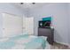 The bedroom features an accent wall, ceiling fan, and sliding door closets at 607 W Tenia Trl, San Tan Valley, AZ 85140