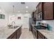A beautifully designed kitchen includes an island, granite countertops, and stainless steel appliances at 607 W Tenia Trl, San Tan Valley, AZ 85140