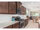 Modern kitchen with granite countertops, stainless steel appliances, and an open layout to the living area at 607 W Tenia Trl, San Tan Valley, AZ 85140