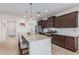 An updated kitchen features a granite island, stainless steel appliances, and tile flooring at 607 W Tenia Trl, San Tan Valley, AZ 85140