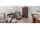 Inviting living room features tile flooring, and an elegant seating area with a bookshelf with glass doors at 607 W Tenia Trl, San Tan Valley, AZ 85140