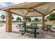 Covered picnic area with multiple tables and stone pillars offers a comfortable space for outdoor dining and recreation at 607 W Tenia Trl, San Tan Valley, AZ 85140
