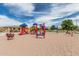Colorful playground equipment with slides, climbers, and spring riders provides a vibrant and engaging play area at 607 W Tenia Trl, San Tan Valley, AZ 85140