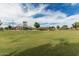 Expansive park with a playground, grassy field, and mature trees offers a perfect blend of recreation and relaxation at 607 W Tenia Trl, San Tan Valley, AZ 85140