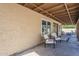Covered back patio features stylish furniture and ample space for relaxation and outdoor entertaining at 656 W Devon Ct, Gilbert, AZ 85233
