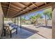 Inviting covered patio overlooks a serene outdoor space with a sparkling pool and lush landscaping at 656 W Devon Ct, Gilbert, AZ 85233