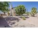 An inviting backyard features a covered patio, a pool and mature trees creating a tranquil outdoor space at 656 W Devon Ct, Gilbert, AZ 85233