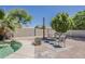 A backyard with a serene pool, lush desert plants, and comfortable patio chairs for relaxation at 656 W Devon Ct, Gilbert, AZ 85233