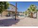 Spacious backyard with a pool, covered patio, and shaded seating area ideal for entertaining at 656 W Devon Ct, Gilbert, AZ 85233