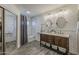 Beautiful bathroom featuring a double sink vanity with framed mirrors, tiled floors, and walk-in shower at 656 W Devon Ct, Gilbert, AZ 85233