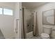 Well-lit bathroom features a shower-tub combo, stylish flooring, and a neutral color palette at 656 W Devon Ct, Gilbert, AZ 85233