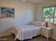 Cozy bedroom with a twin bed, side table and beachy artwork creating a peaceful retreat at 656 W Devon Ct, Gilbert, AZ 85233