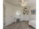 Bright bedroom boasts a vanity, a ceiling fan, floating shelves, and neutral-toned walls and carpet at 656 W Devon Ct, Gilbert, AZ 85233
