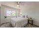Comfortable bedroom features a ceiling fan, neutral decor, and a bright window seat for relaxing at 656 W Devon Ct, Gilbert, AZ 85233