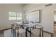 Bright dining room with modern glass table, stylish chairs, and neutral decor near a window at 656 W Devon Ct, Gilbert, AZ 85233