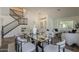 Bright dining area featuring modern furnishings and staircase at 656 W Devon Ct, Gilbert, AZ 85233