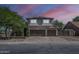 Charming two-story home featuring a spacious three-car garage and solar panels against a vibrant pink and purple sky at 656 W Devon Ct, Gilbert, AZ 85233