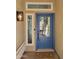 Inviting blue front door with glass panes, sidelight window, and decorative light fixture creating a warm entryway at 656 W Devon Ct, Gilbert, AZ 85233