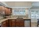 Well-lit kitchen features wood cabinets, tile backsplash, and stainless steel dishwasher at 656 W Devon Ct, Gilbert, AZ 85233