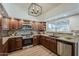 Well-lit kitchen features stainless steel appliances, neutral counters, and designer lighting at 656 W Devon Ct, Gilbert, AZ 85233