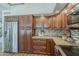 Well-appointed kitchen features stainless steel appliances, wood cabinetry, and neutral stone countertops at 656 W Devon Ct, Gilbert, AZ 85233