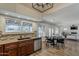 Open kitchen and dining area with wood floors and a view of the living room at 656 W Devon Ct, Gilbert, AZ 85233