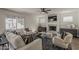 Spacious living room with a fireplace, ceiling fan, and ample natural light at 656 W Devon Ct, Gilbert, AZ 85233
