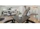 Open-concept living room with fireplace, wood floors, staircase, and dining area at 656 W Devon Ct, Gilbert, AZ 85233