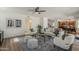 Open concept living area with wood floors, neutral furniture, and access to other rooms at 656 W Devon Ct, Gilbert, AZ 85233