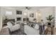 Comfortable living room with a fireplace, ceiling fan, and neutral-toned furniture at 656 W Devon Ct, Gilbert, AZ 85233