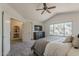 Bright main bedroom features a large window, ceiling fan, and doorway leading to a closet or bathroom at 656 W Devon Ct, Gilbert, AZ 85233
