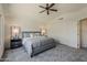Spacious main bedroom featuring a ceiling fan, stylish decor, and ensuite bathroom at 656 W Devon Ct, Gilbert, AZ 85233
