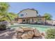 Beautiful backyard with a pool, covered patio, and well-maintained landscaping, perfect for relaxation at 656 W Devon Ct, Gilbert, AZ 85233