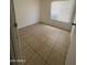 Small bedroom featuring tile flooring and window at 6605 N 46Th Ln, Glendale, AZ 85301