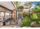 Lush backyard featuring a stone pathway, mature plantings, and modern architecture at 7117 E Rancho Vista Dr # 1012, Scottsdale, AZ 85251