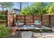Charming backyard with a tranquil seating area, gravel landscaping, and a privacy fence at 7117 E Rancho Vista Dr # 1012, Scottsdale, AZ 85251