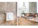Elegant bathroom featuring a unique stone sink, travertine walls, and designer fixtures at 7117 E Rancho Vista Dr # 1012, Scottsdale, AZ 85251