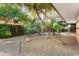 Serene courtyard with mature trees, gravel ground cover, and ambient lighting at 7117 E Rancho Vista Dr # 1012, Scottsdale, AZ 85251
