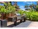 Community outdoor grill area with two stainless steel BBQ grills and stone countertops at 7117 E Rancho Vista Dr # 1012, Scottsdale, AZ 85251