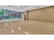 Bright, open gym space with hardwood floors, and large windows overlooking a natural outdoor scene at 7117 E Rancho Vista Dr # 1012, Scottsdale, AZ 85251