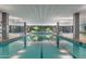 Community indoor swimming pool with blue tile, columns, and ample lighting at 7117 E Rancho Vista Dr # 1012, Scottsdale, AZ 85251